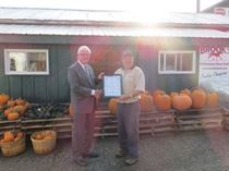 David congratulates John Davis on Davis Feed & Farm Supply's 25th anniversary on October 16, 2021